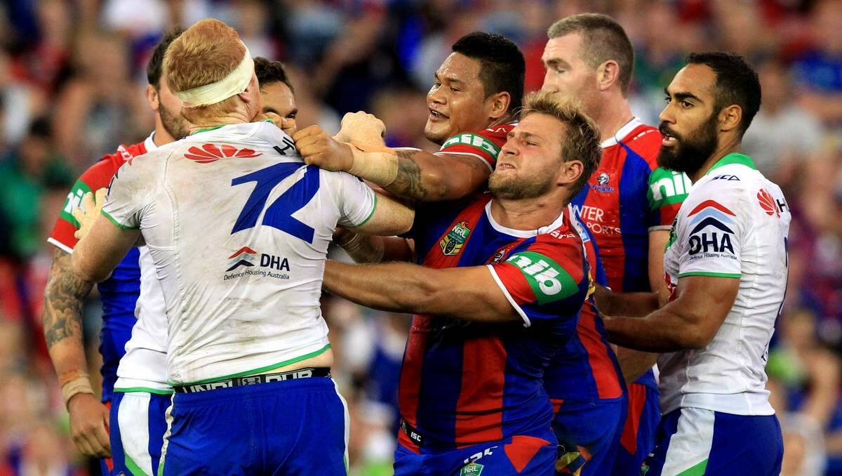TENSION: A mid-game fight breaks out on the field between Newcastle Knights players and Canberra Raiders.