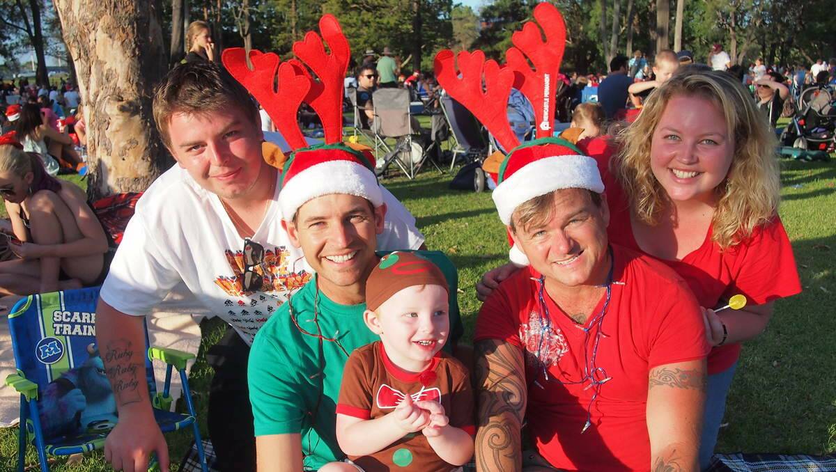 Shane Laurie, of Glendale with Joel Deas of Shortland; Jonah Deas-Laurie, 2, Glendale; Glen Floyd of Shortland; and Breanna Deas of Glendale at Newcastle Permanent annual Carols By Candlelight, Speers Point Park.