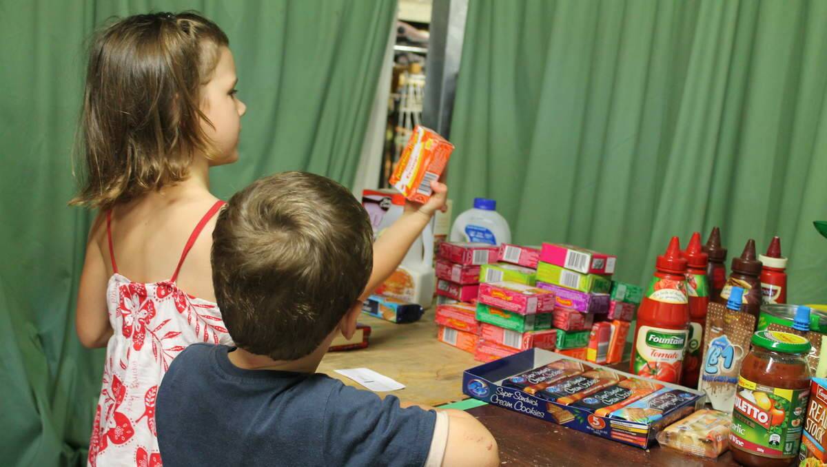 HELPERS: St Luke’s Uniting Church Community Commission volunteers pack hampers to distribute for Project Blessing. Molly and James Dare, aged 5 and 3, of Valentine.