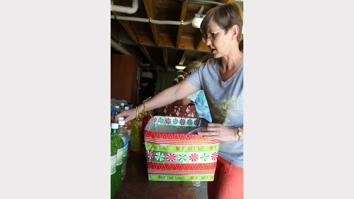 HELPERS: St Luke’s Uniting Church Community Commission volunteers pack hampers to distribute for Project Blessing. Volunteer Wendy Webb, of Belmont.