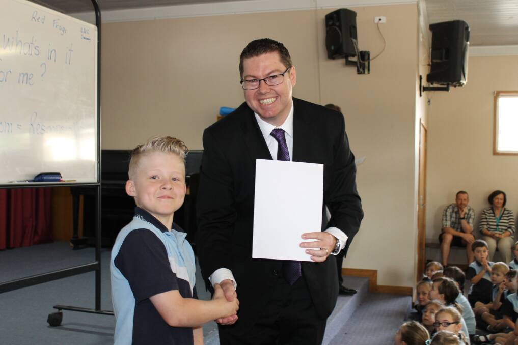 Charlton MP Pat Conroy and the winner of his Christmas card competition, Koby Robarts from Wallsend South Public School.