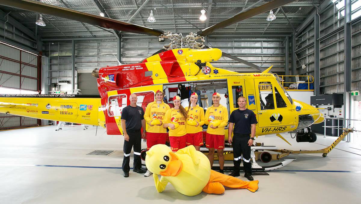 Westpac Rescue Helicopter Service crewman Nathan Langham, Hunter Surf Lifesaving volunteers Zachary Donnelly, Amy Charlton, Georgia Bendall, and Edward Ingle and service crewman Michael Legge with the Ducks 4 Dollars mascot.