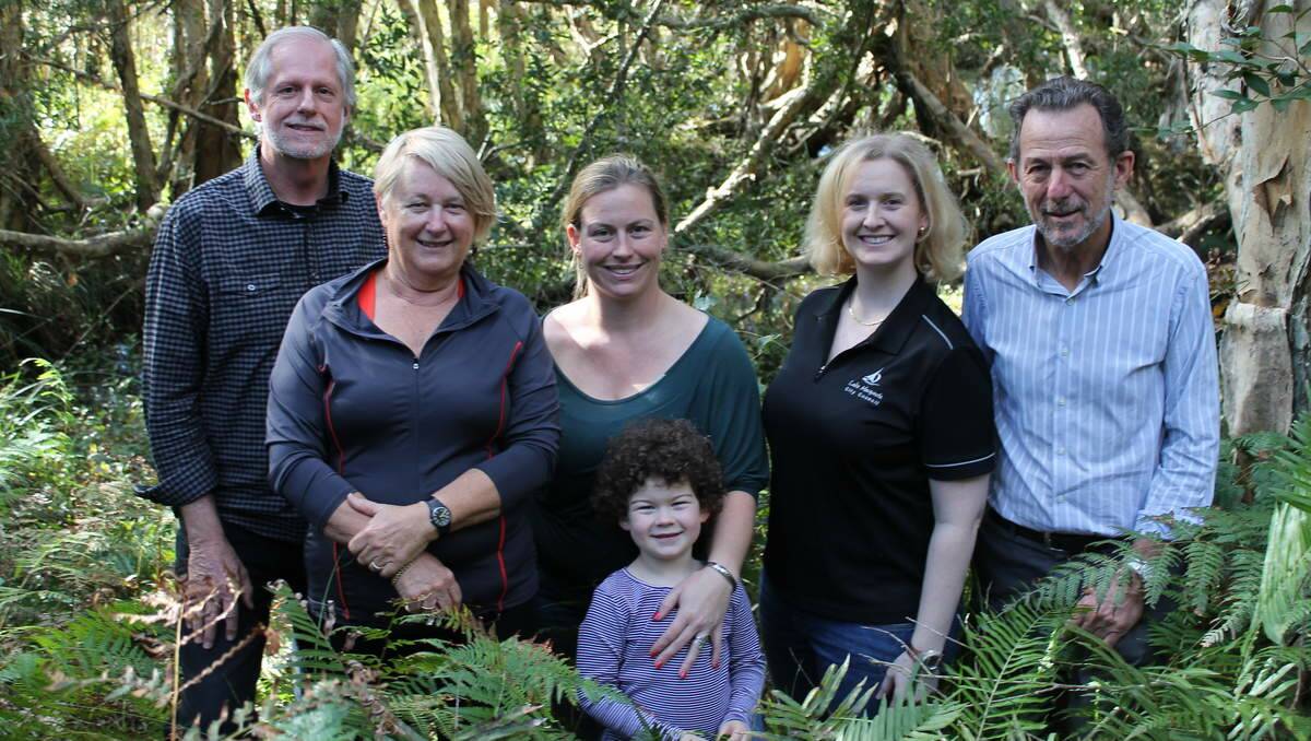 HAPPY IN THEIR WORK: Volunteers Helen Rogers, Tamsin Martin and her daughter Rosie, from the Belmont Wetlands State Park Trust, together with trust chairman Greg Wright and Lake Macquarie City Council's Karen Marples and Greg Giles.