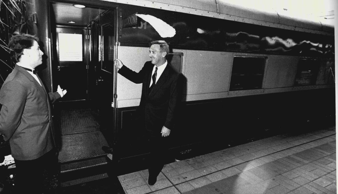 ALL ABOARD: Michael Wansey, centre, boarding the Southern Cross Express at Central Station, Sydney, in February 1988. Picture: Quentin Jones