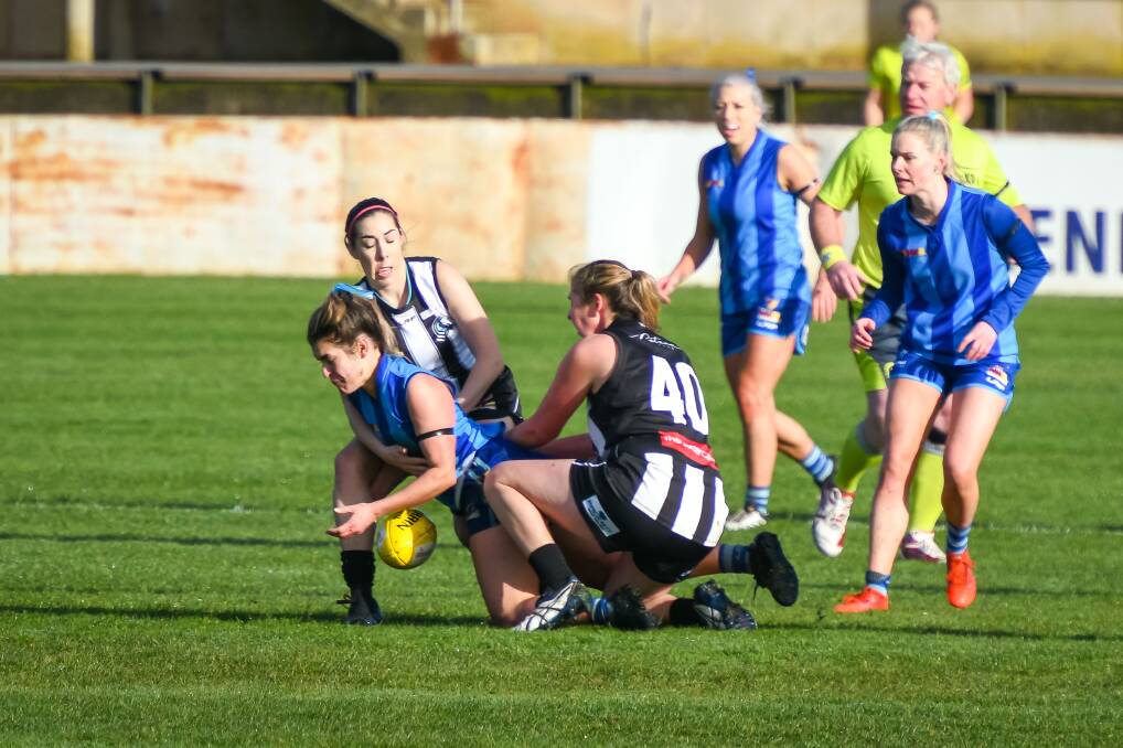 Penguin's Lila Wijesingha-Frohmader is put under pressure by two Magpies in the NWFL Women's grand final. Picture: Simon Sturzaker 