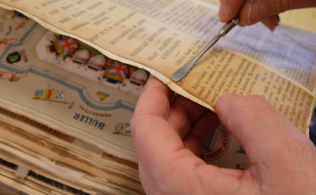 Preparing a scrapbook of theatre memorabilia for digitisation. Picture: The National Library of Australia