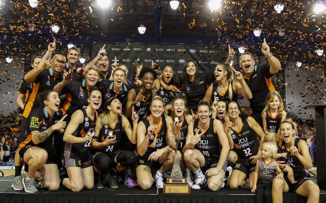 CHAMPIONS: Townsville Fire players celebrate after their grand final series win against Melbourne Boomers on Sunday night. Pictures: AAP