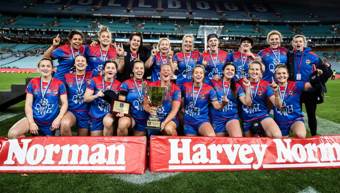 SPOILS OF VICTORY: Skipper Bec Young and teammates with the premiership trophy. Picture: NRL Photos