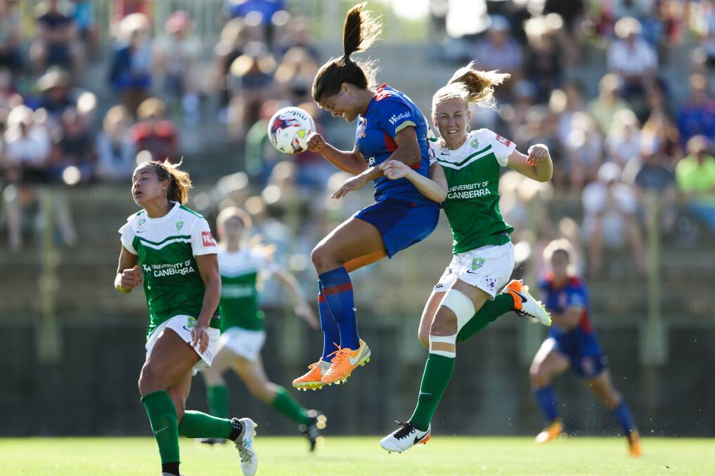 DISAPPOINTMENT: Newcastle Jets striker Katie Stengel wins a header against Canberra United on Sunday at No.2 Sportsground. Pictures: Jonathan Carroll