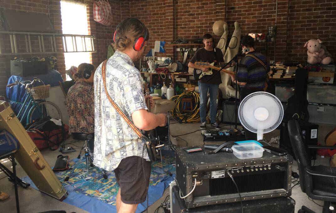 BAND DAYS: Cody Brougham and his mates rehearsing in his Warabrook garage that was destroyed by fire.