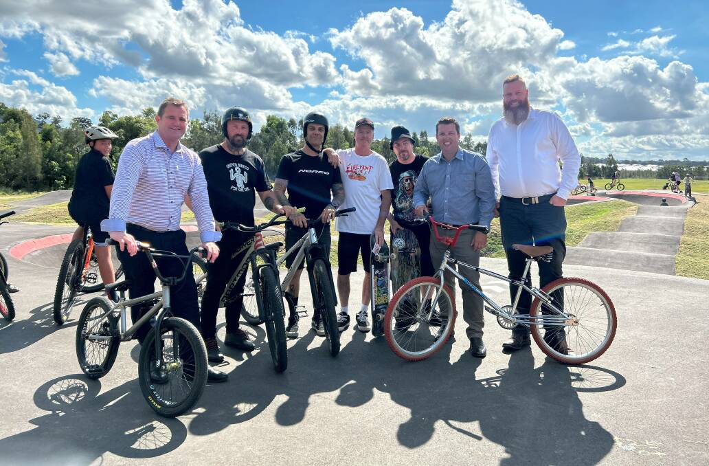State Member for Cessnock Clayton Barr, Cessnock City mayor Jay Suvaal, and Federal Member for Hunter Dan Repacholi, standing with BMX riders and skateboarders on the new Neville Tomlinson BMX Facility. Picture supplied