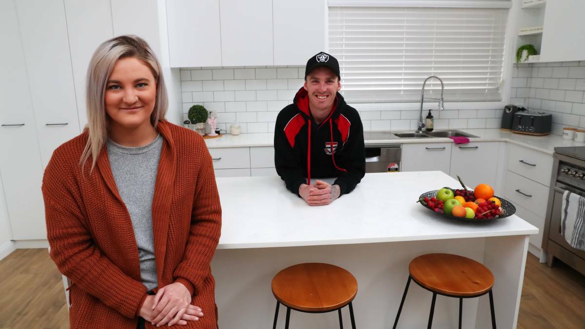 DONE AND DUSTED: Brianna and Jarryd Mildren in their mum's secretly renovated house. Photo: Emma Hillier