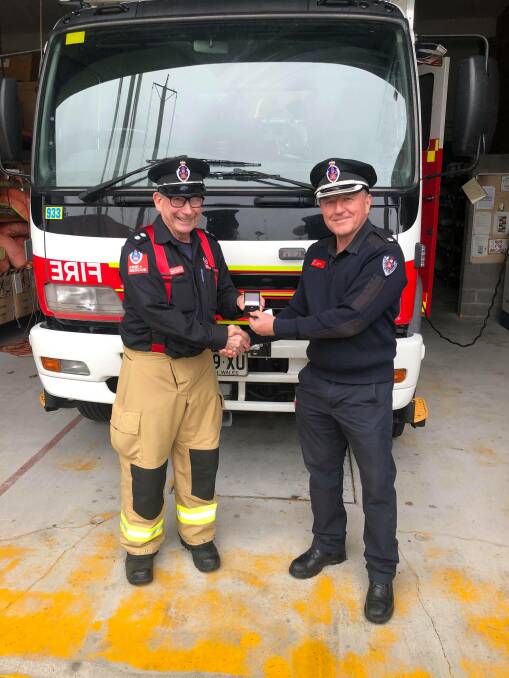 CONGRATULATIONS: Station officer Bob McDonald is awarded for 50 years service by Metro North 1 duty commander Inspector Peter Nies. Picture: supplied