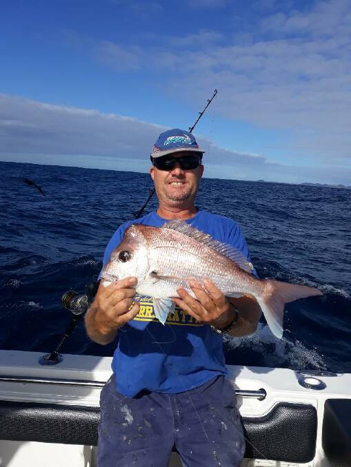 OUT IN THE BLUE: Cameron Judd shows off a snapper caught off Broughton Island.