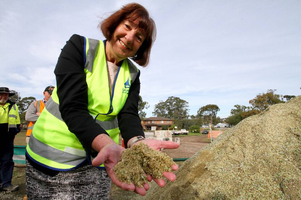 RECYCLING INNOVATION: The Mayor, Cr Fraser, with the ‘glass sand’ that will be used in city works projects.