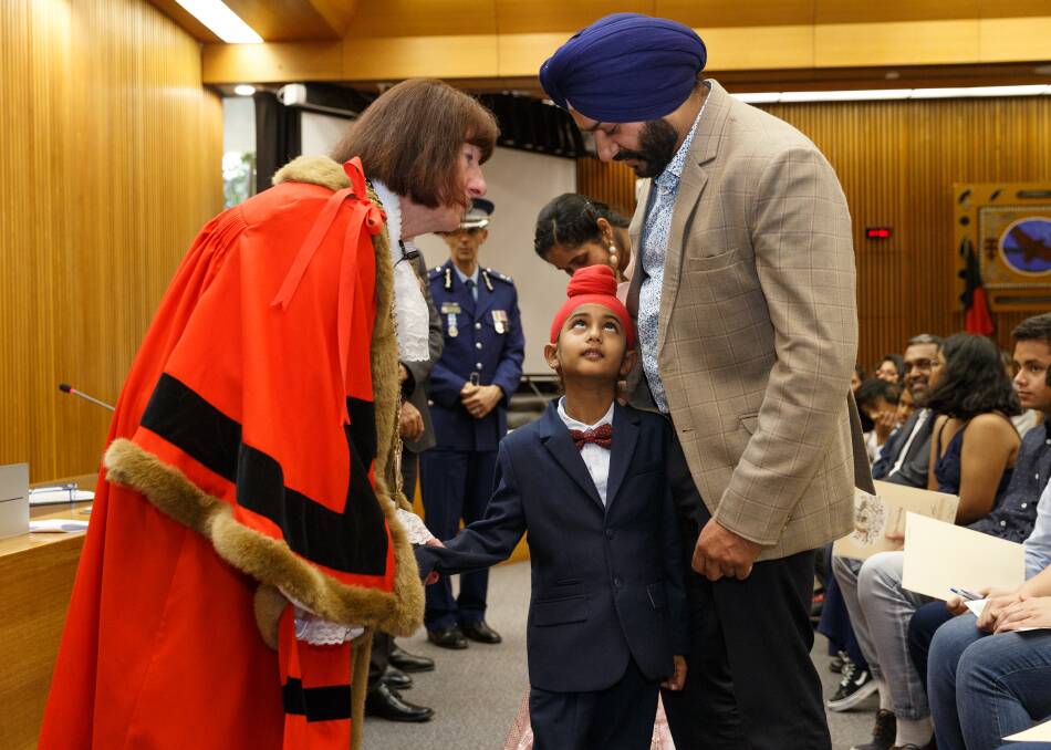 WELCOME: Biragam Singh and his father Balwinder Singh Sidhu receive their citizenship certificates from mayor Kay Fraser. Picture: Max Mason-Hubers MMH