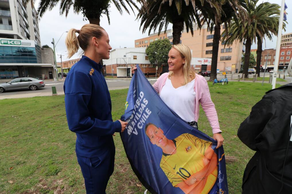 DRAWCARD: Emily van Egmond and the Lord Mayor with one of the large banners that will help promote the Matildas v Chile match in the city next month. 