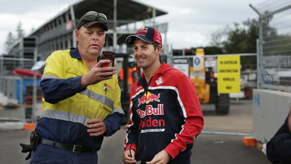 IN DEMAND: Jamie Whincup poses for a selfie with a track worker on Monday. Picture: Simone De Peak