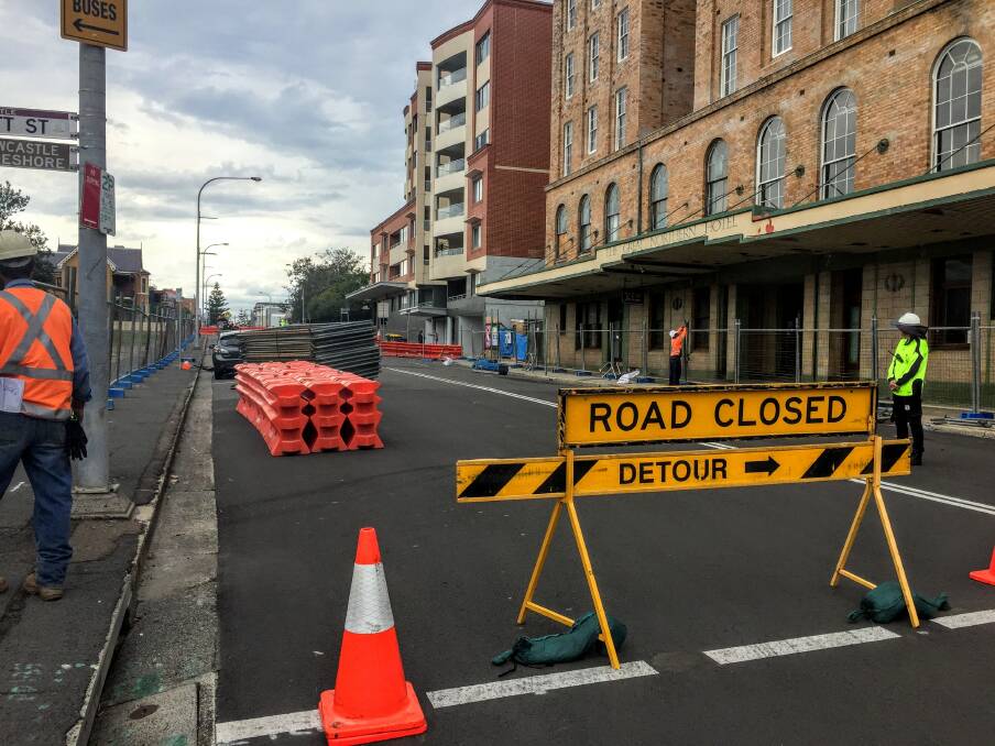 NO-GO ZONE: Workers close off Scott Street outside the Great Northern Hotel on Tuesday to make way for light rail construction. 
