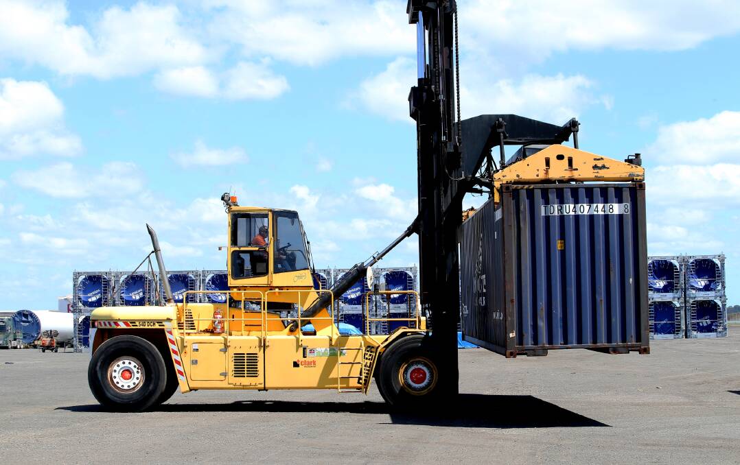 A forklift carries a shipping container during a media event last year at Port of Newcastle's fledgling freight terminal at Mayfield. Picture by Peter Lorimer 