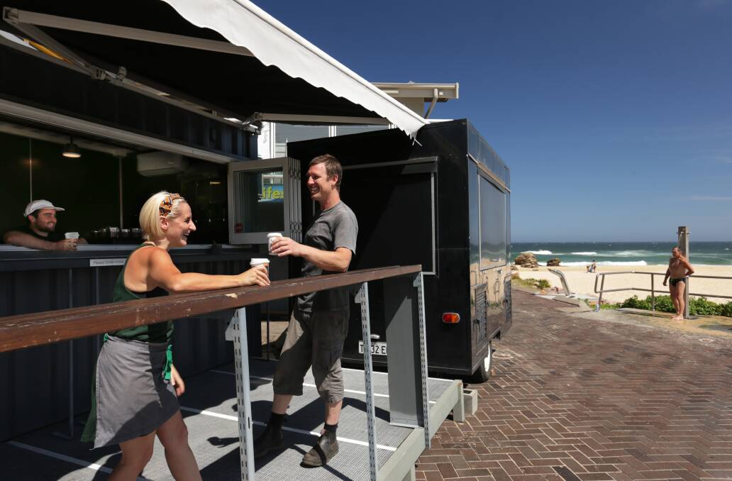 Cargo Espresso: From left, barista Joshua McCabe with shipping container cafe owners Maree and Murray Ruse, who have set up at Redhead Beach Surf Lifesaving Club for the summer season. Picture: Simone De Peak