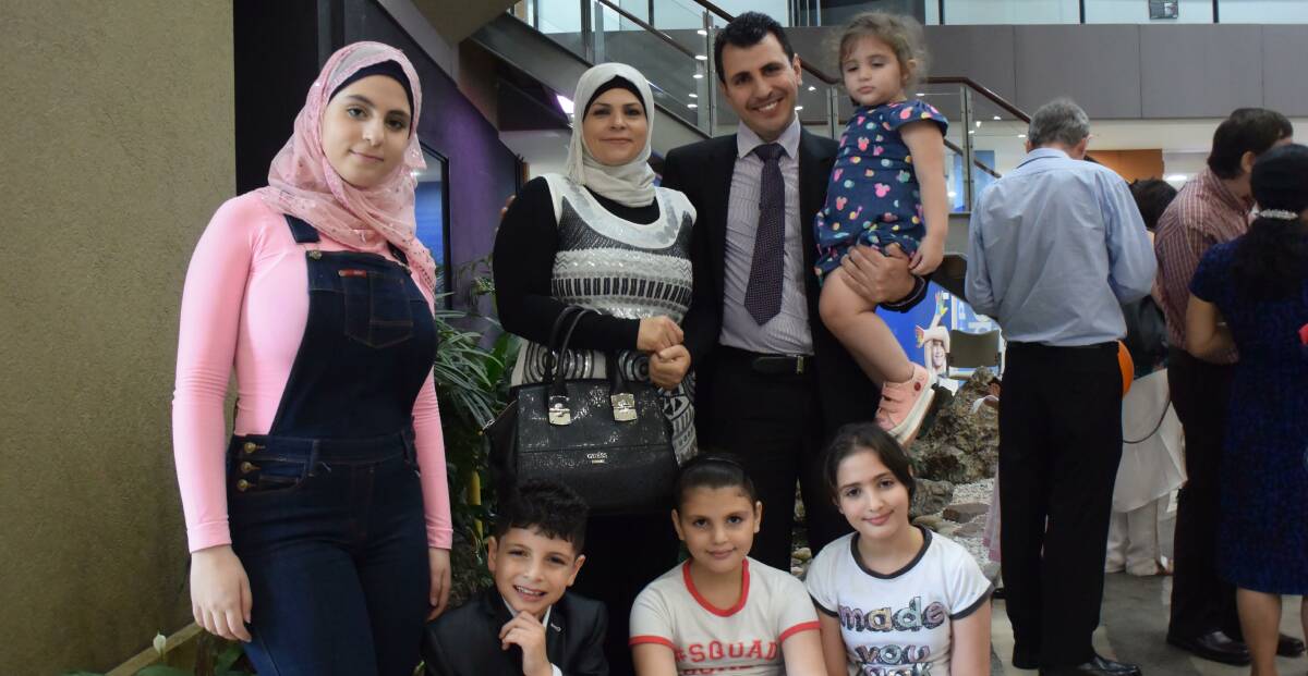 Proud: Mohammed Alawneh and his family, who arrived from Jordan in 2010, at the Lake Macquarie citizenship ceremony. 