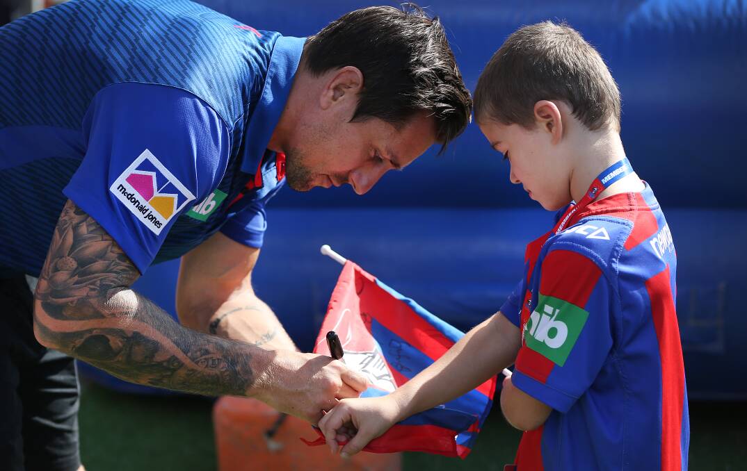 Mitchell Pearce signs an autograph