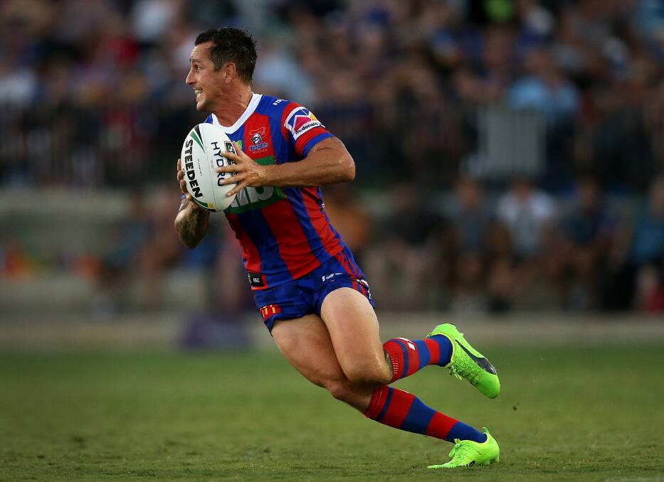 Reality check: Mitchell Pearce runs the ball for the Knights on Saturday night. The Newcastle playmaker says his side was put in their place by the Eels a fortnight out from the start of the NRL season. Picture: Marina Neil.
