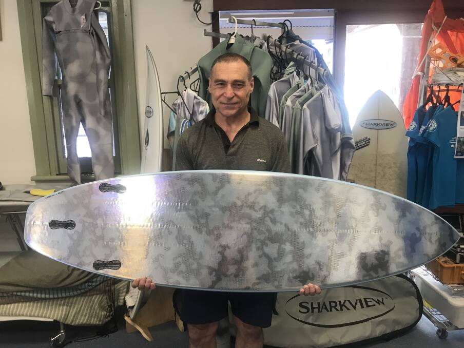 SAFER: Rob Carraro holds one of his Sharkview surfboards which makes surfers less visible to sharks while in the water. Picture: Melinda McMillan