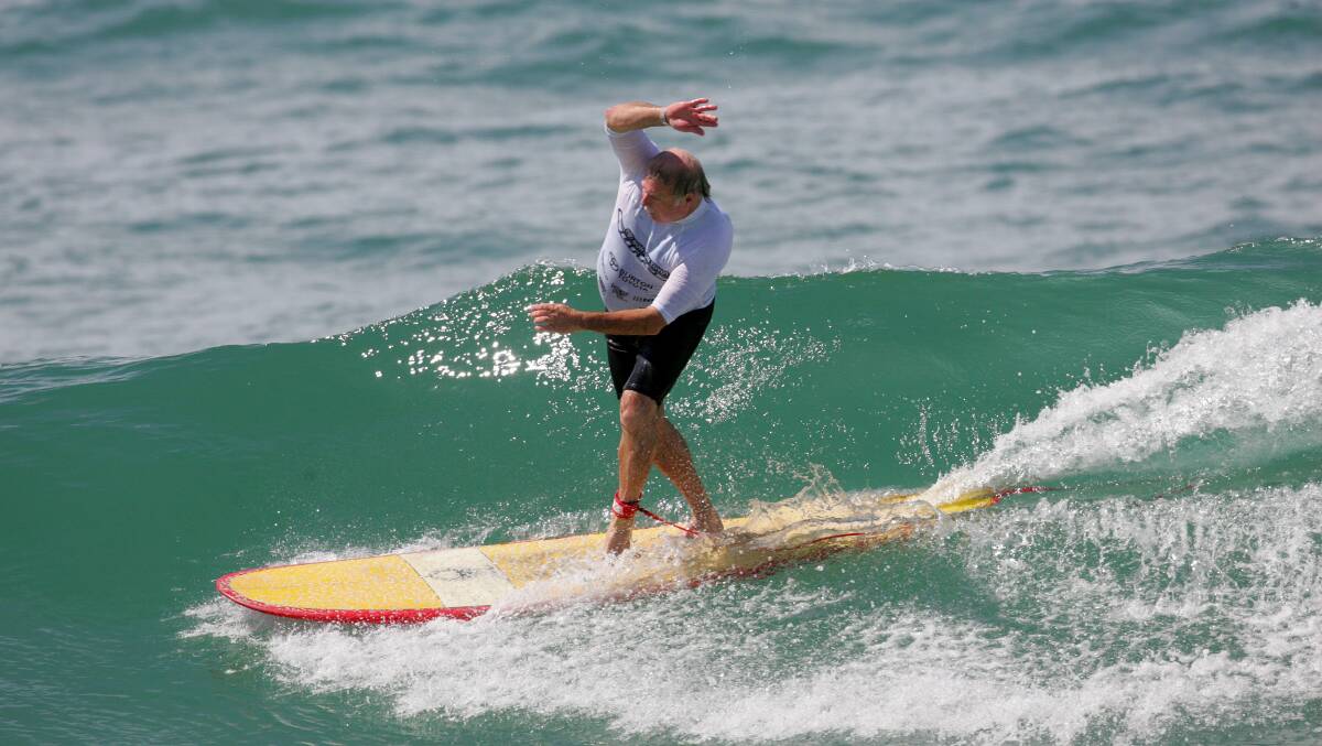 HANGING TEN: Longboards are back at Lake Macquarie for the Longboard Classic. Roger Clements catches a wave. 