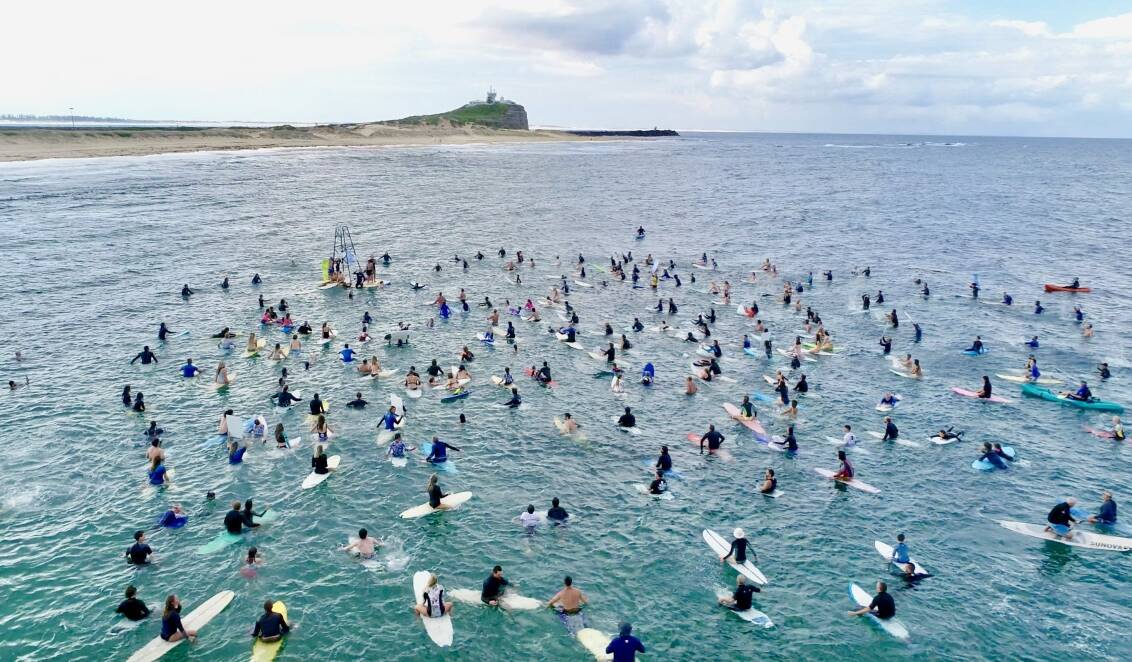 WAVE OF OBJECTION: Surfers took to the water at Nobbys Beach on Sunday to protest against plans for more seismic testing off the coast of Newcastle. Picture: Kailin Pasin