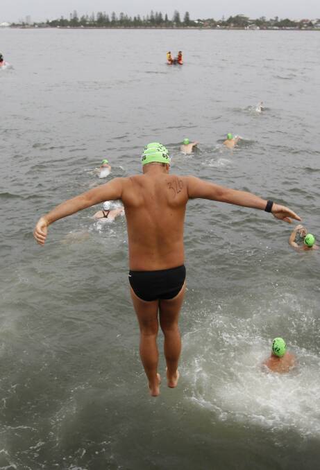 THE PLUNGE: Swimmers take the plunge for the Australia Day Stockton to Newcastle harbour swim. Picture: Peter Stoop