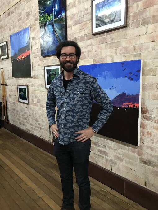 Patrick Mavety with works currently on exhibition at Coal & Cedar. 