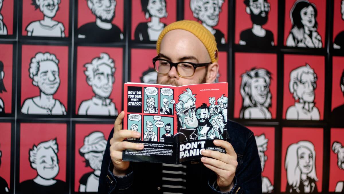 COMIC KID: Ben Mitchell holds a copy of his second comic book, Don't Panic. He will soon release his third, Ghost Beach. Picture: Mitch Lee