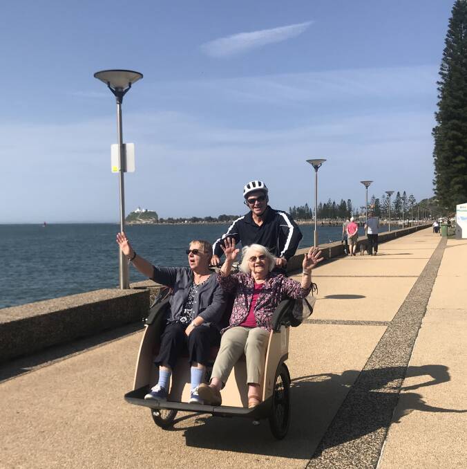 EASY RIDERS: Margaret Fullick and Shirley Loder with Ken Jury piloting the bike as they ride along Newcastle Foreshore. Picture: Melinda McMillan