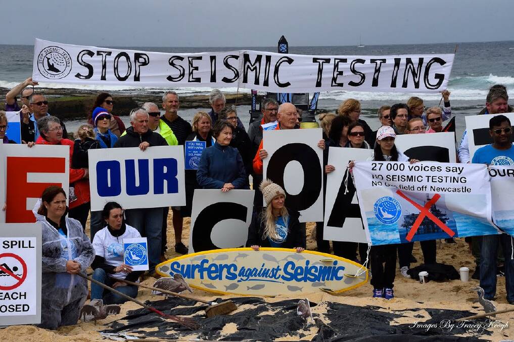 CLEAR MESSAGE: Protesters gather at Bar Beach on Saturday to show opposition to any further seismic testing off the Newcastle coast. Picture: Tracey Keogh