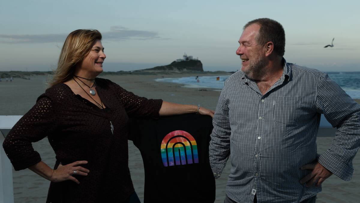 Newcastle Pride organisers Lee-Anne McDougall and Ivan Skaines at Nobbys Beach with one of the festival's t-shirts. Picture: Max Mason-Hubers 