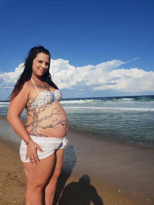 TATTOO BUMP: Alisha Dawson, of Toronto, proudly shows off her tattoo and baby bump. Picture: supplied