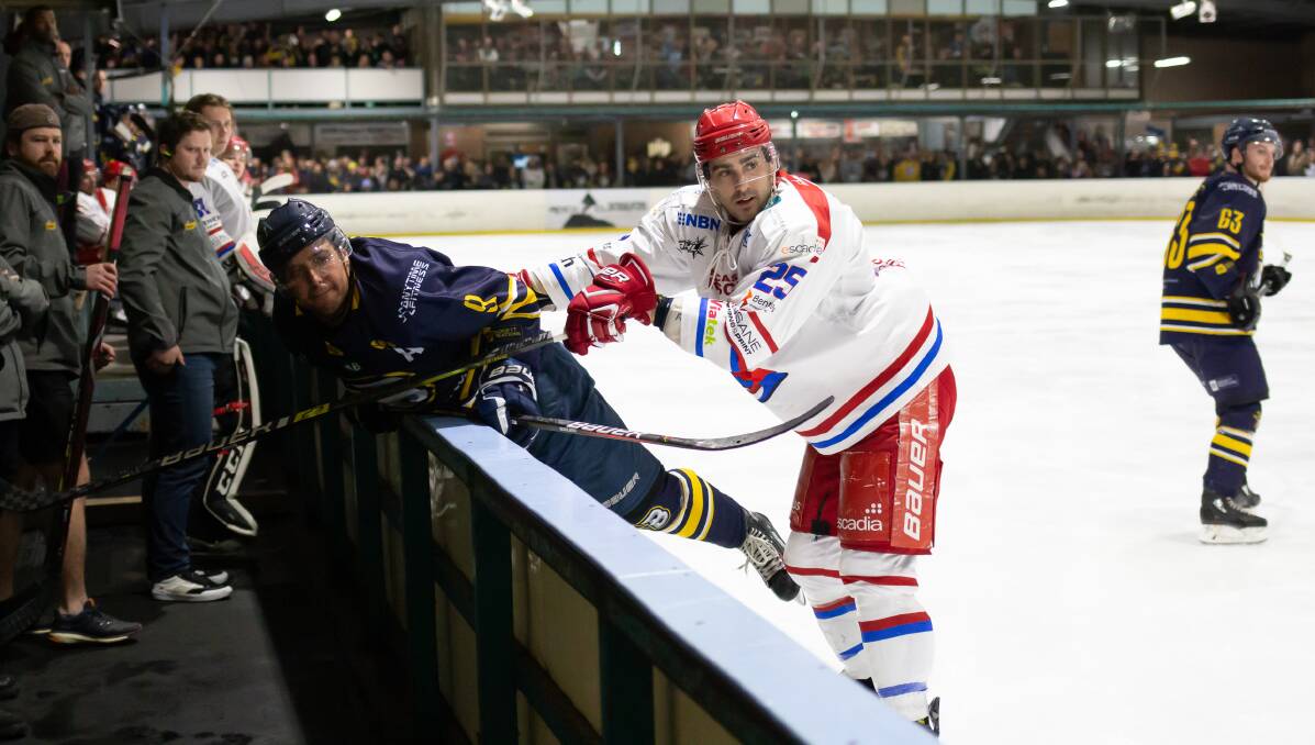 HARD HITS: Newcastle Northstars player Dave Ferrari (right) checks Brave opponent Wehebe Darge in Canberra on Saturday night. The visitors lost 6-1. Picture: Scott Stevenson