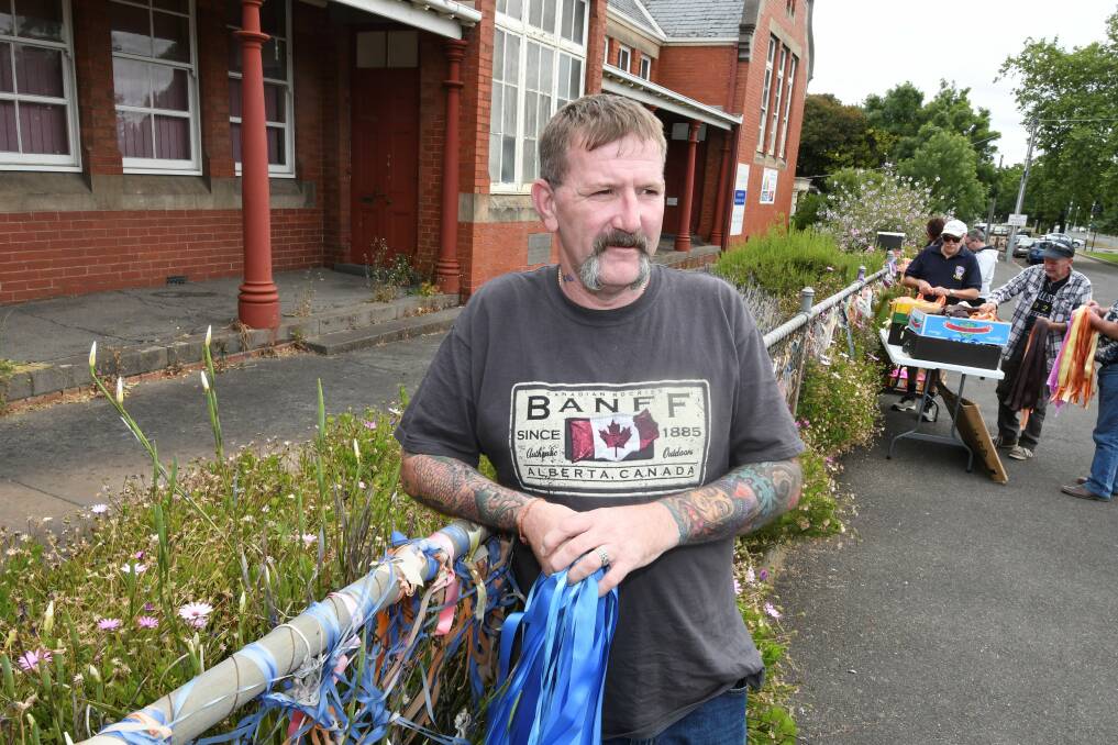 IMPORTANT: Abuse survivor Paul Levey helped place new ribbons on the 'loud fence' outside St Alipius on Saturday. Picture: Lachlan Bence 