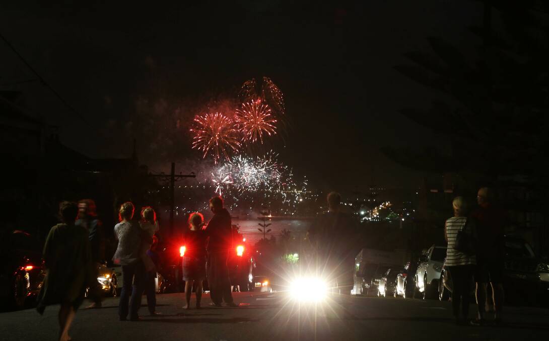 BIG BANG: Revellers at the top of Perkins Street watch the 2017 Newcastle New Year's Eve fireworks. The display that did not proceed on December 31 will burst into colours after dark on Australia Day. Picture: Marina Neil