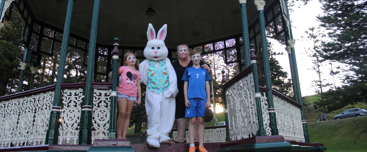 HIPPITY HOP: Bella Gibson, 6, Tanya Gibson, and Charlie Gibson, 10, of Cardiff with the Easter Bunny, aka Dannielle Owen, at King Edward Park on Sunday.