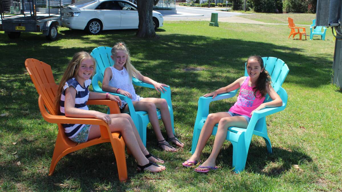 JUST CHILLIN': Lake Macquarie residents Ellie Stock, 11, Malaika Blair-White, 11, and Hayley Baker, 11, embrace the council's place-making trial at Belmont Wharf.