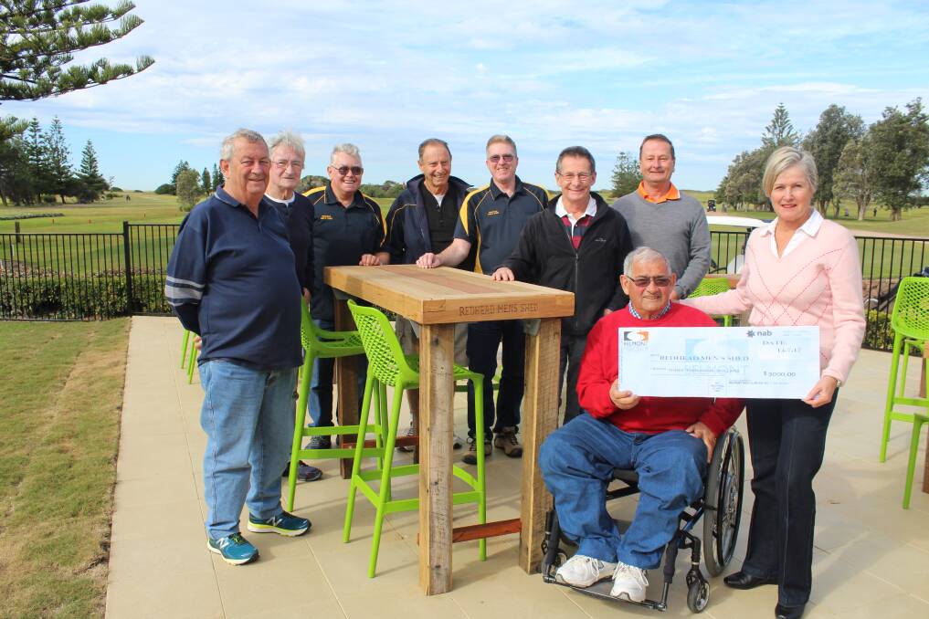 GOOD USE: Belmont Golf Club president Lyn Cooper presents a $3000 donation to Redhead Men's Shed member Bob Hadden while other members and golf club general manager Glenn Howard admire at the finished product.
