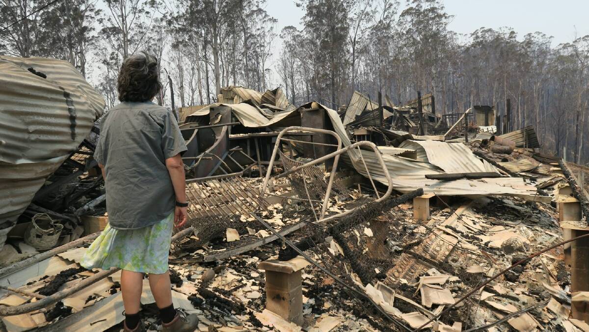 GiGi Welsh stands in front of what's left of her home at Yarranbella the day after fires tore through the region in November 2019. Photo: Jess Wallace
