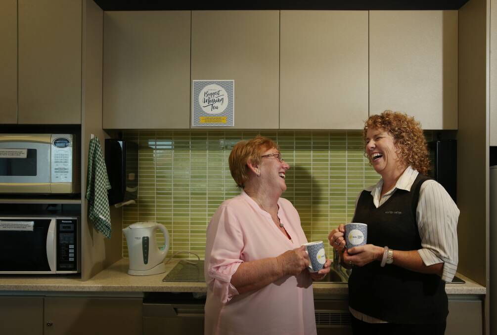 HAVING A LAUGH: Hunter Water's Cathy Jarvis, 63, and Jill Burke, 53, share a laugh and cuppa ahead of Australia's Biggest Morning Tea on Thursday. Picture: Simone De Peak.