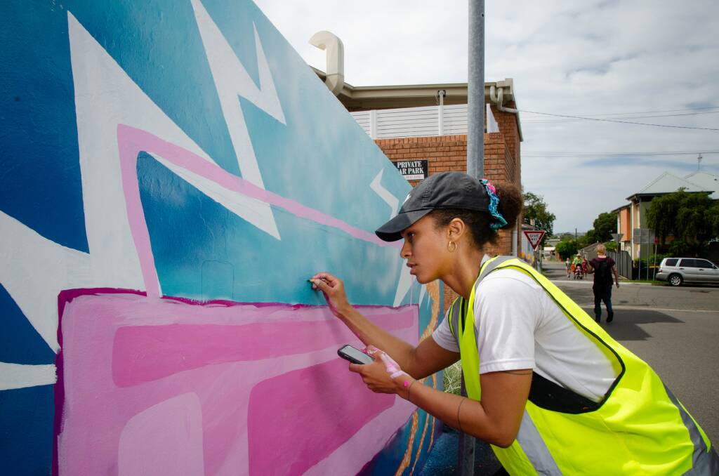 Waratah West artist Jessica Lemire works on her beetbox crab monster mural on Alma Lane as part of the New Lambton iteration of the long-running Little Festival. Picture by Simon McCarthy