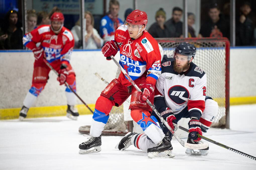 Newcastle Northstars forward Richard Tesarik battles Melbourne Ice captain Lliam Webster for the puck in Sunday's clash at Hunter Ice Skating Staium. Ice won 4-3. Picture: PowerPlay Photographics