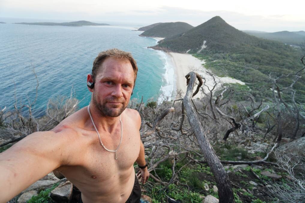 The Maitland runner, pictured at the top of Mount Tomaree in Port Stephens, will attempt to run the Great North Walk from Newcastle to Sydney and back within 100 hours. He is also hosting three running events prior to the June GNW run, which the community is invited to join in on.