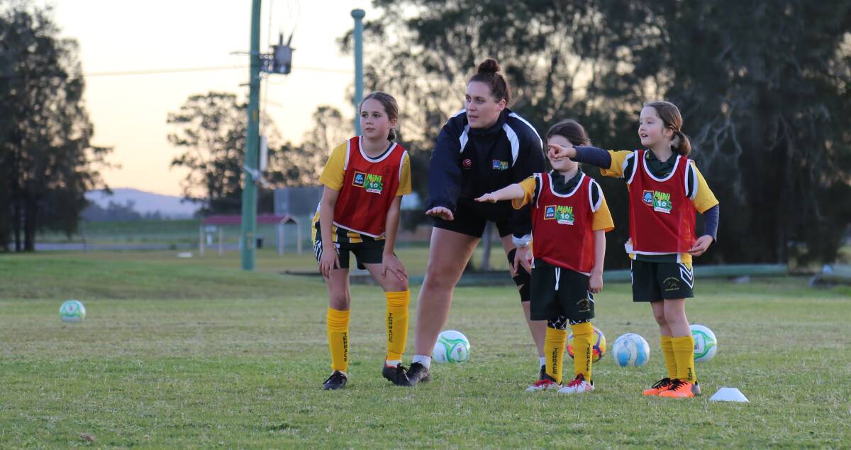 Northern NSW Football's female participation officer Holly Ayton with Raymond Terrace Soccer Club's mini roo girls (aged 6 to 11).